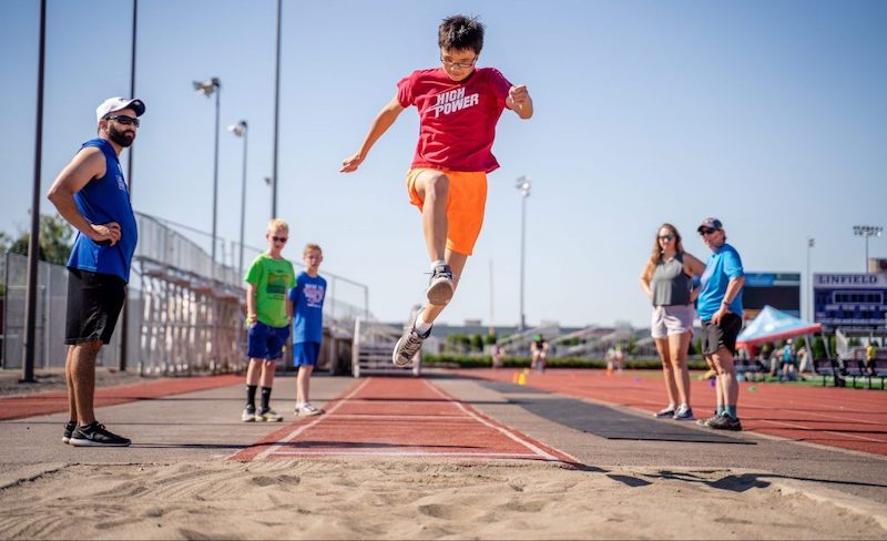Young boy in the air from a long jump.