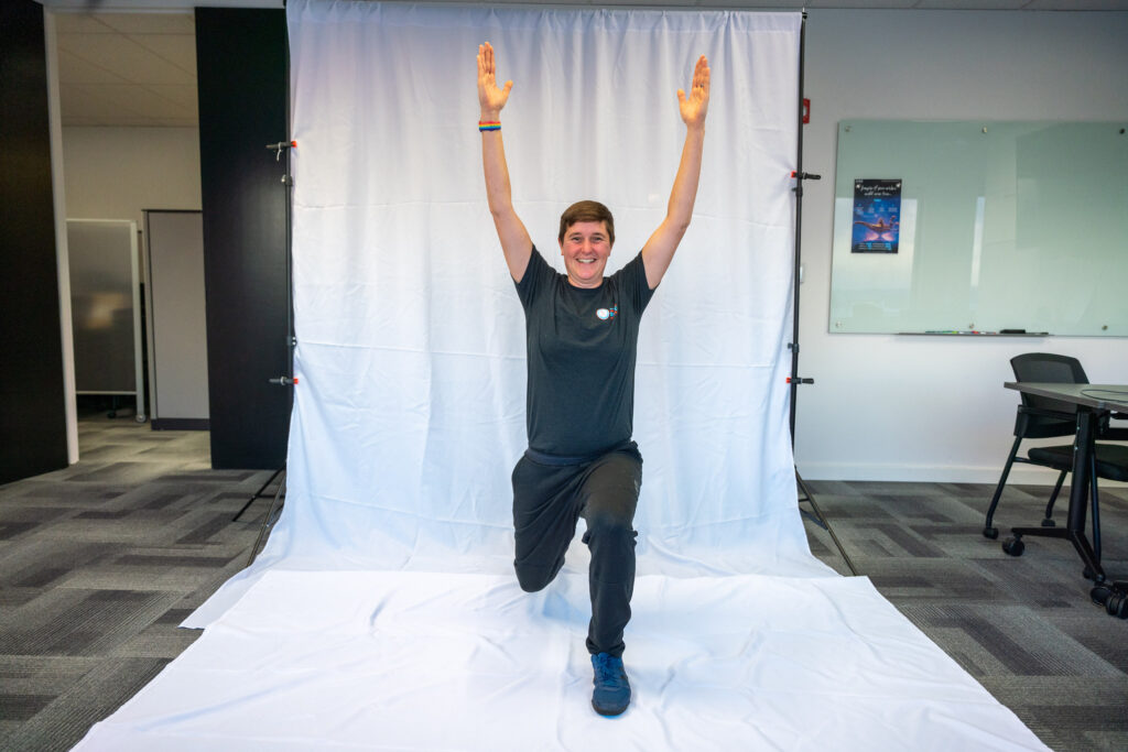 NWABA staff member demonstrating warrior one yoga pose.